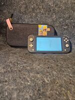 Nintendo Switch Lite Handheld Console - Gray. W/ charger and princess peach case